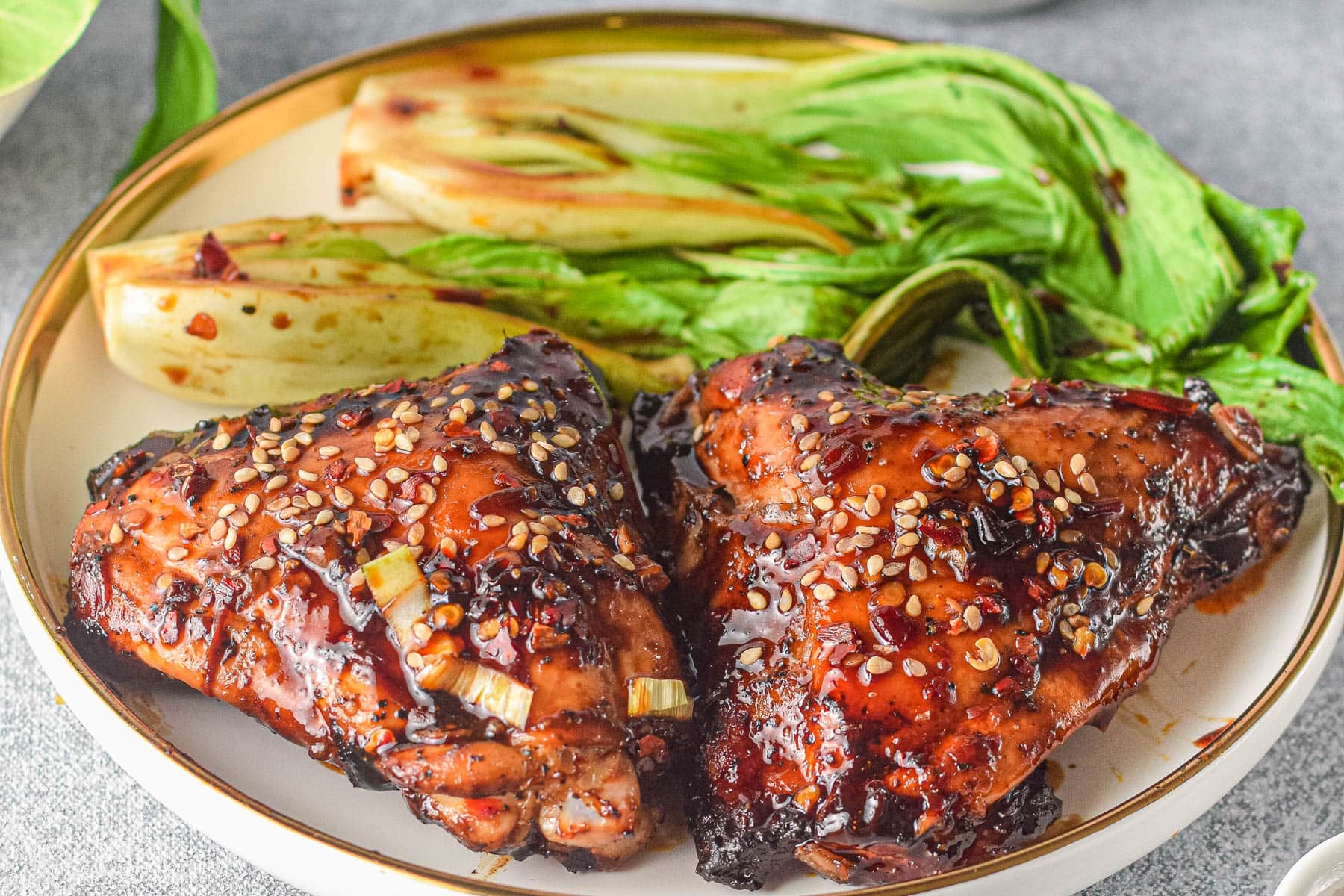 Asian chicken with sesame seeds on a plate.