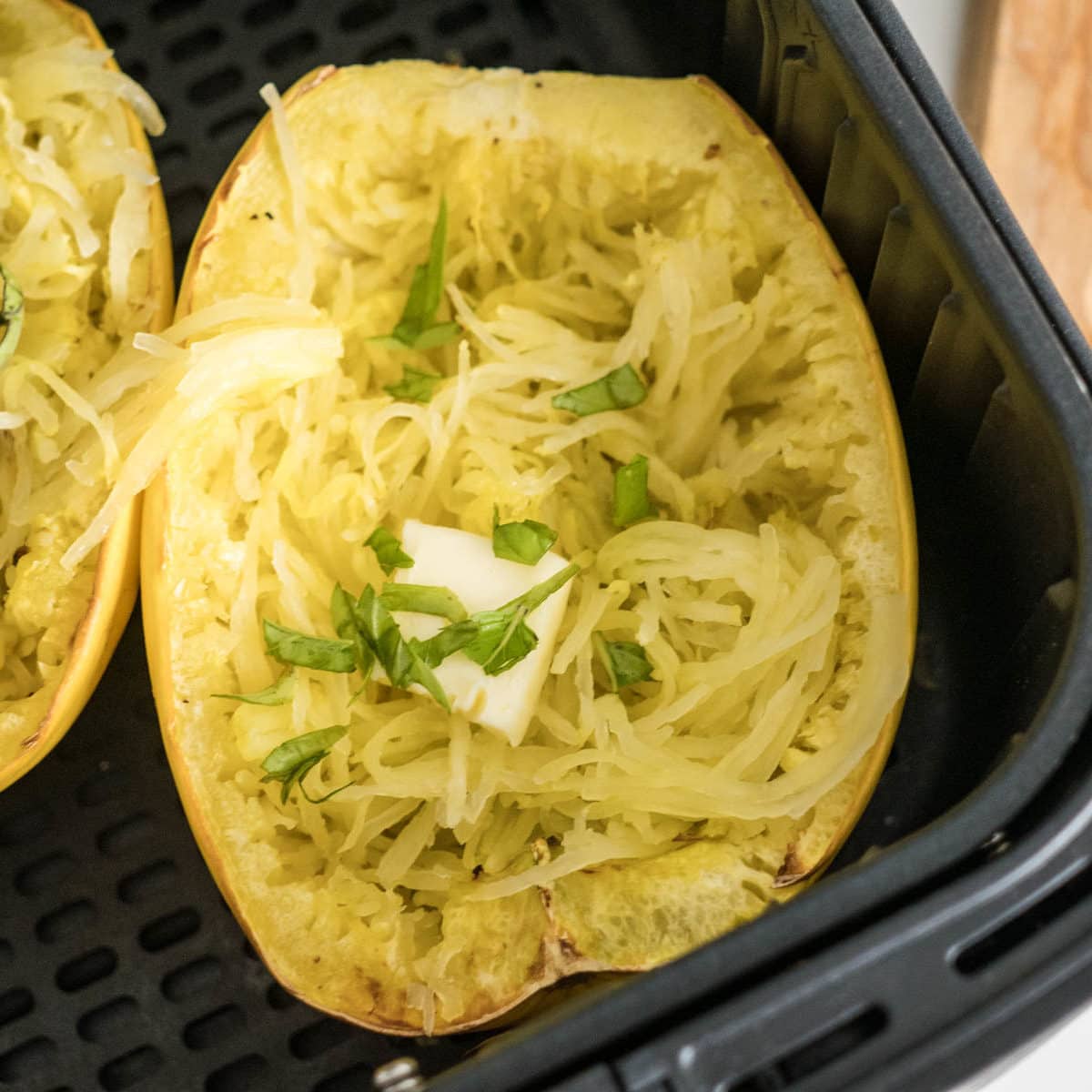 Top view of cooked spaghetti squash with some on a fork.