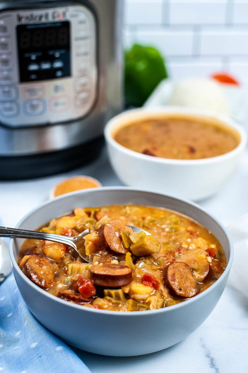 bowl of gumbo in front of pressure cooker