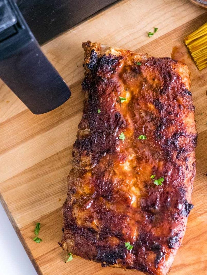 ribs on cutting board in front of air fryer