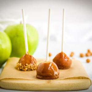 mini caramel apples on a cutting board