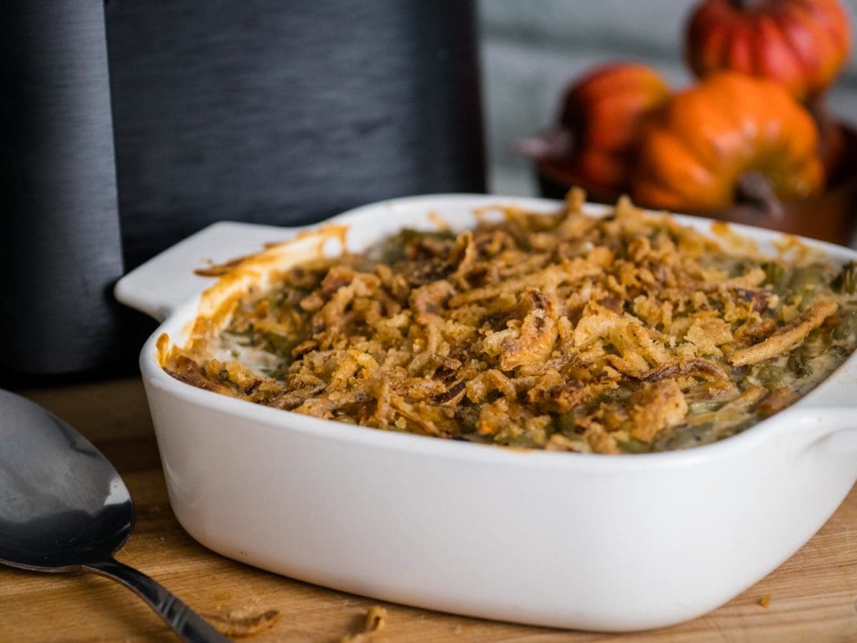green bean casserole in a dish in front of air fryer