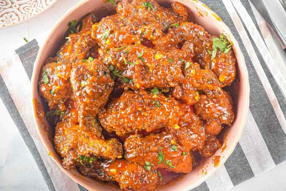 top view of bowl of wings with sauce