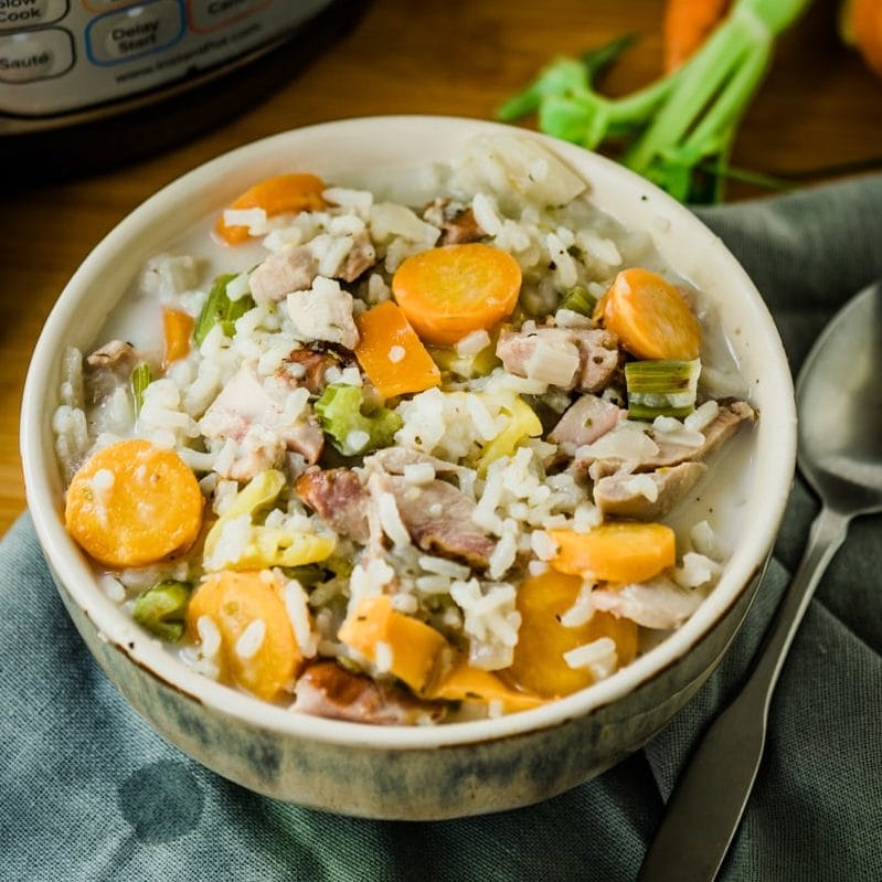 Instant pot turkey soup with rice in front of pressure cooker