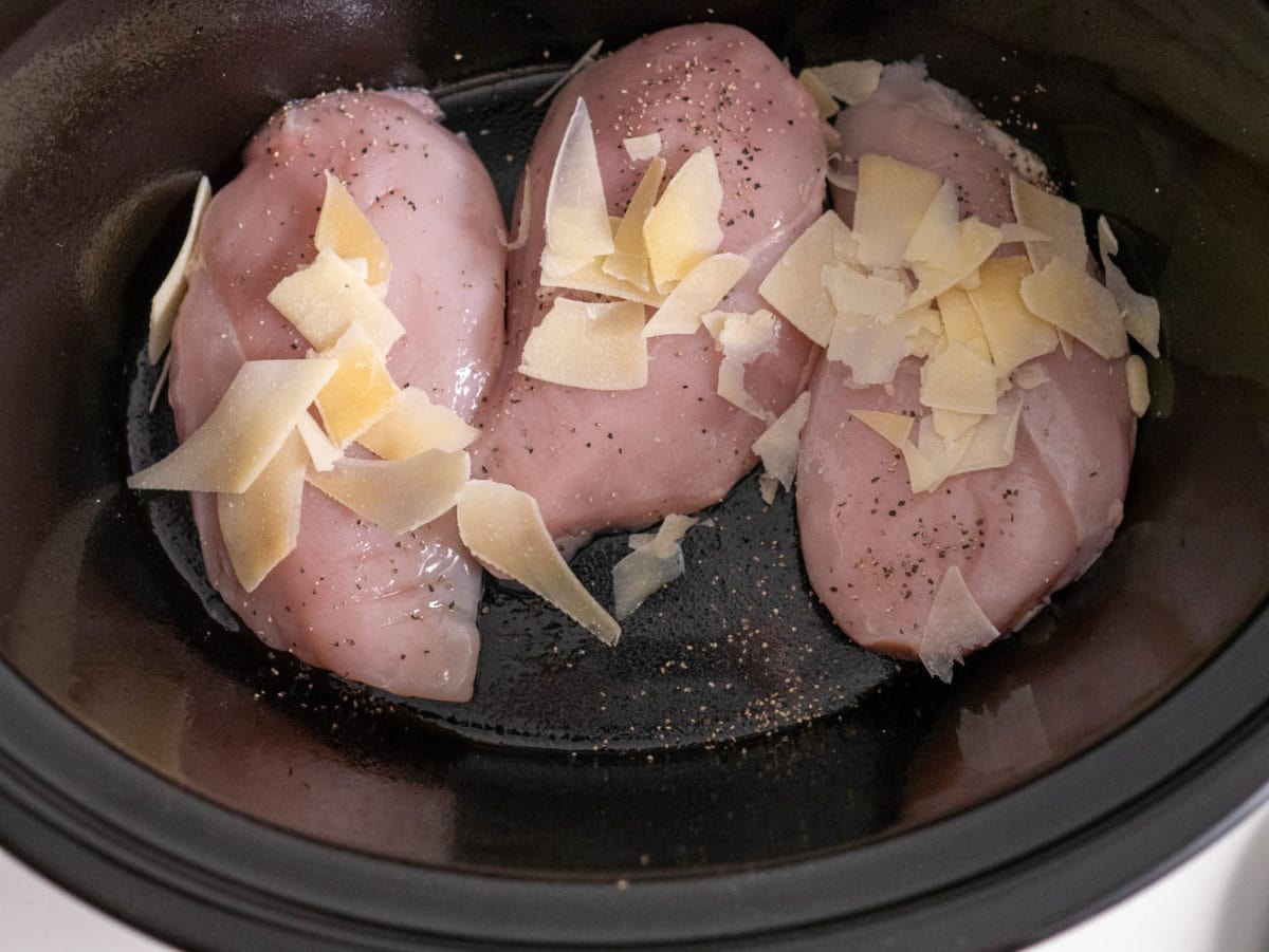adding the chicken to the crock pot