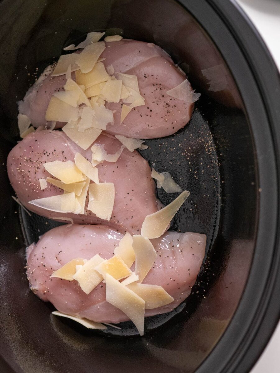 adding the chicken to the crock pot