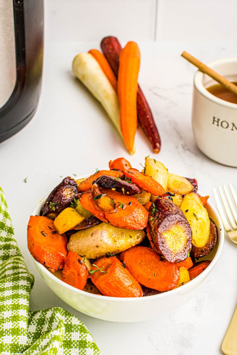 carrots in a bowl in front of air fryer