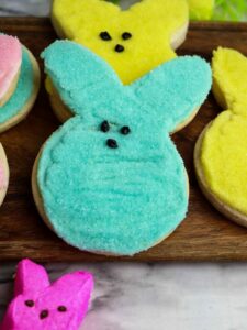 Peeps cookies on a wooden cutting board.