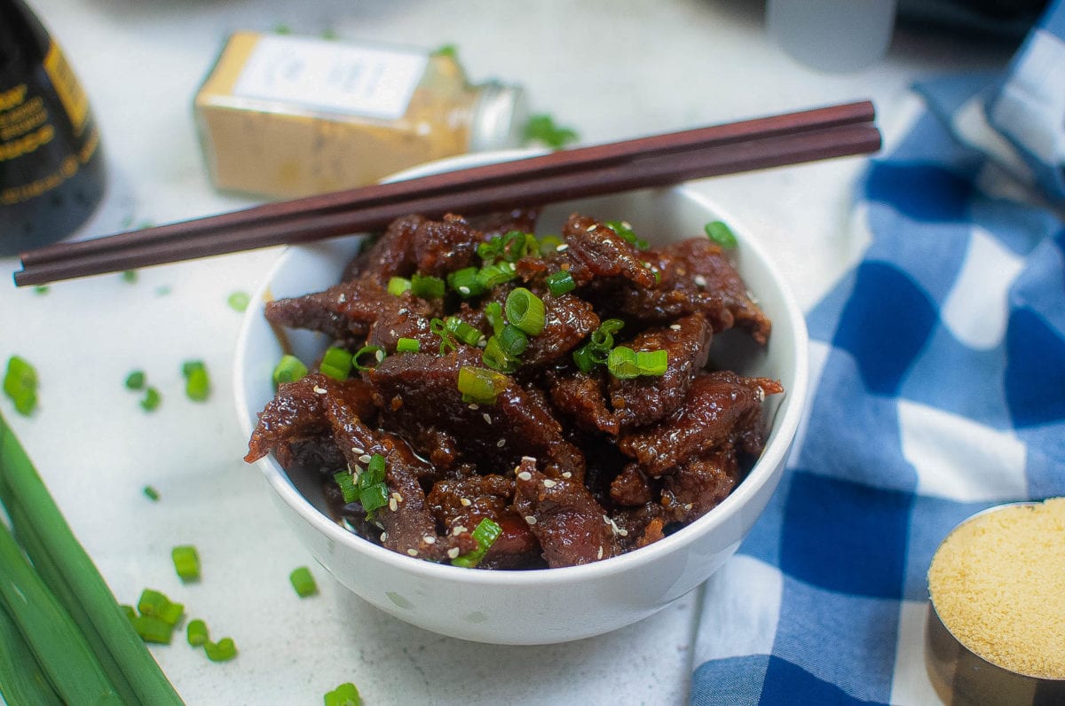 Mongolian beef in a bowl in front of air fryer