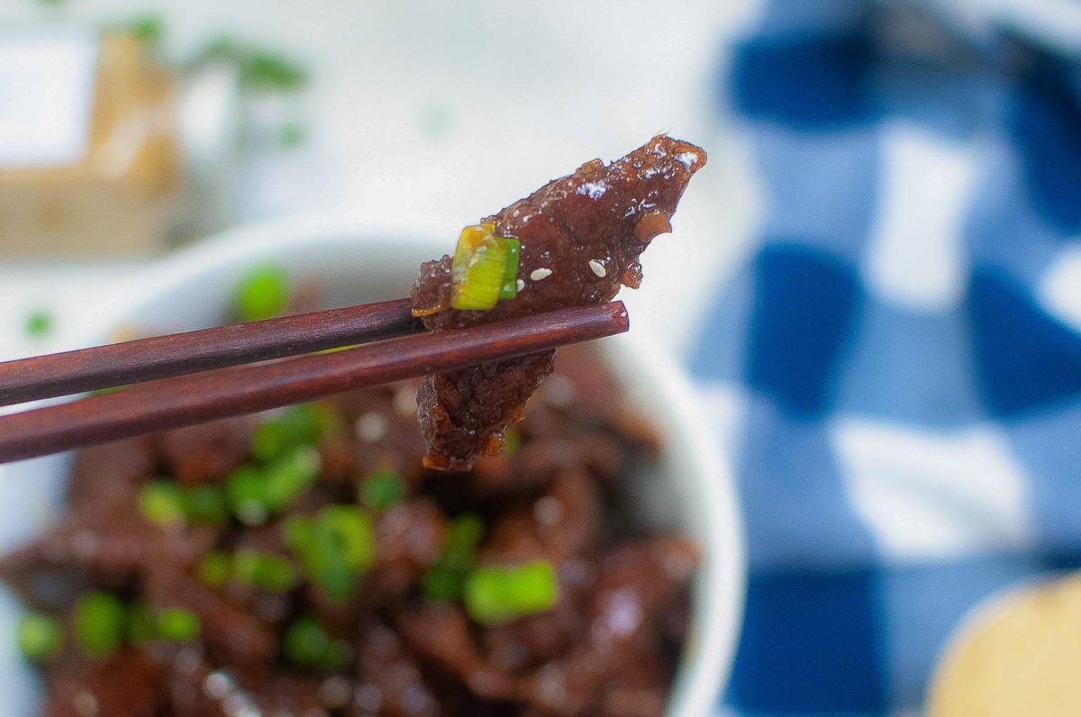 piece of Mongolian beef picked up with chopsticks