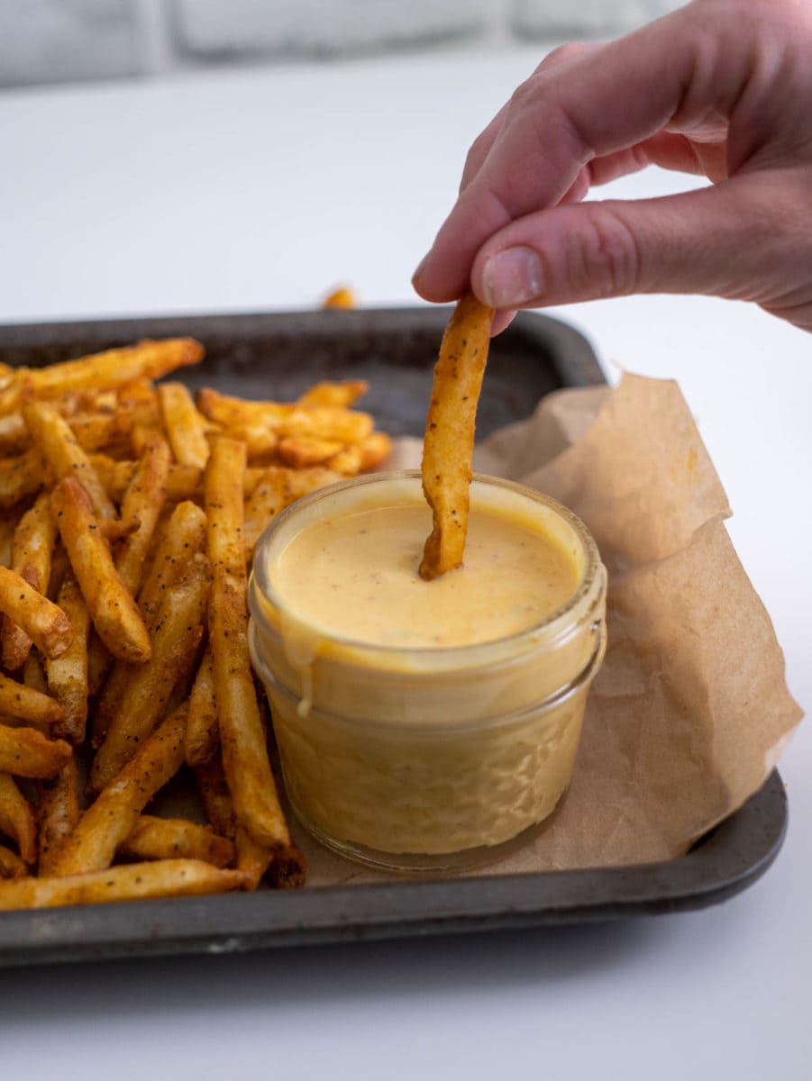 dipping a fry in the homemade Chick-fil-A sauce