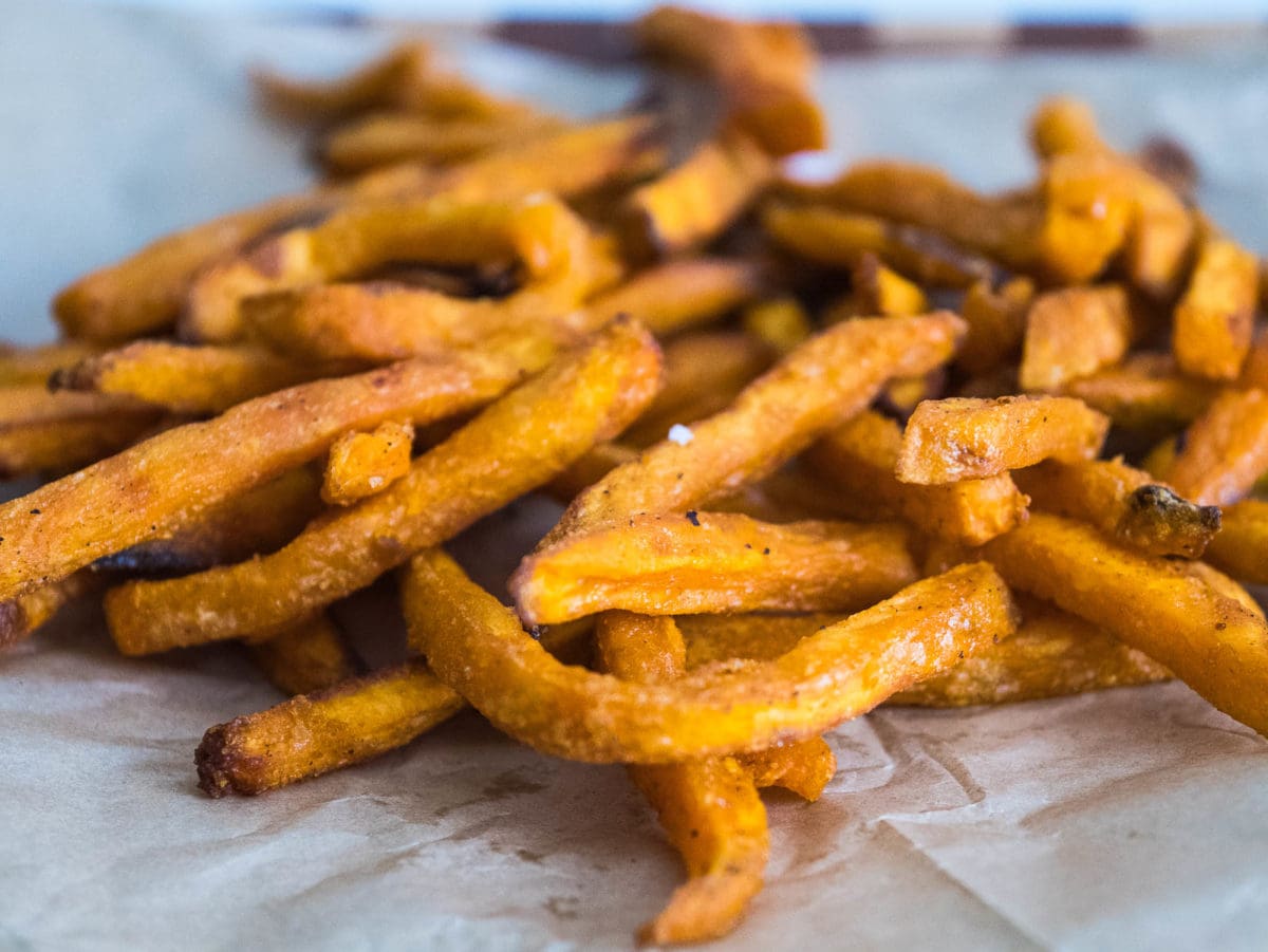 close up of fries on parchment paper