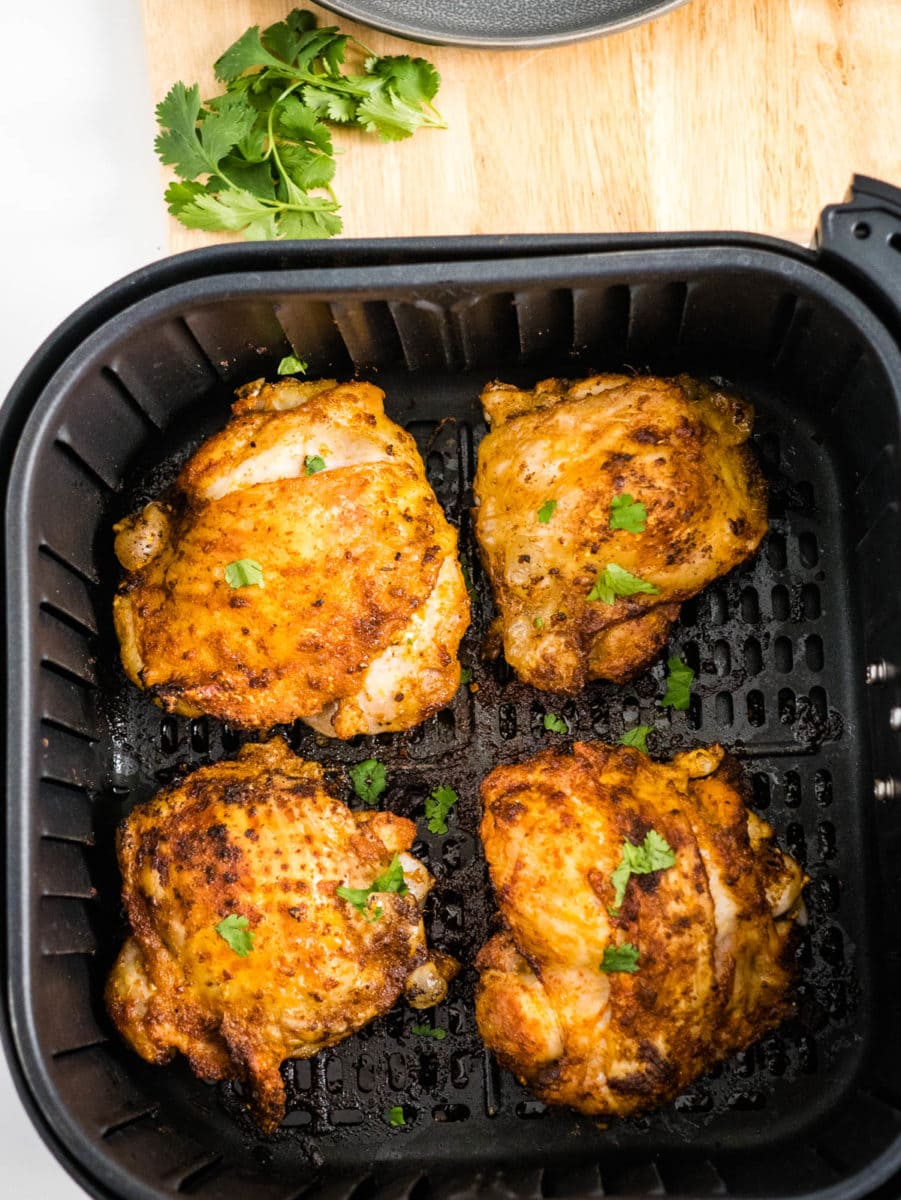 cooked chicken thighs in the air fryer basket