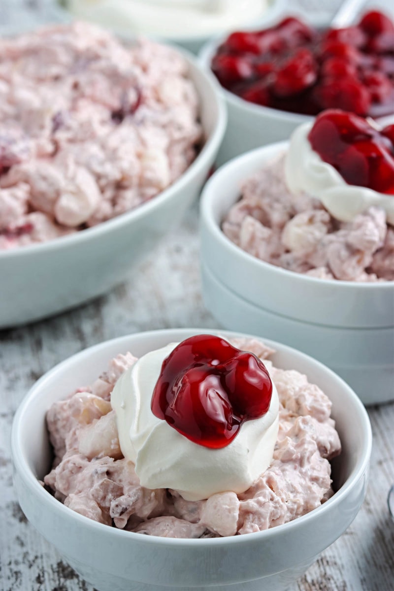 cherry salad topped with whipped cream and cherries