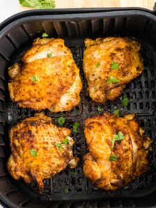 cooked chicken thighs in the air fryer basket