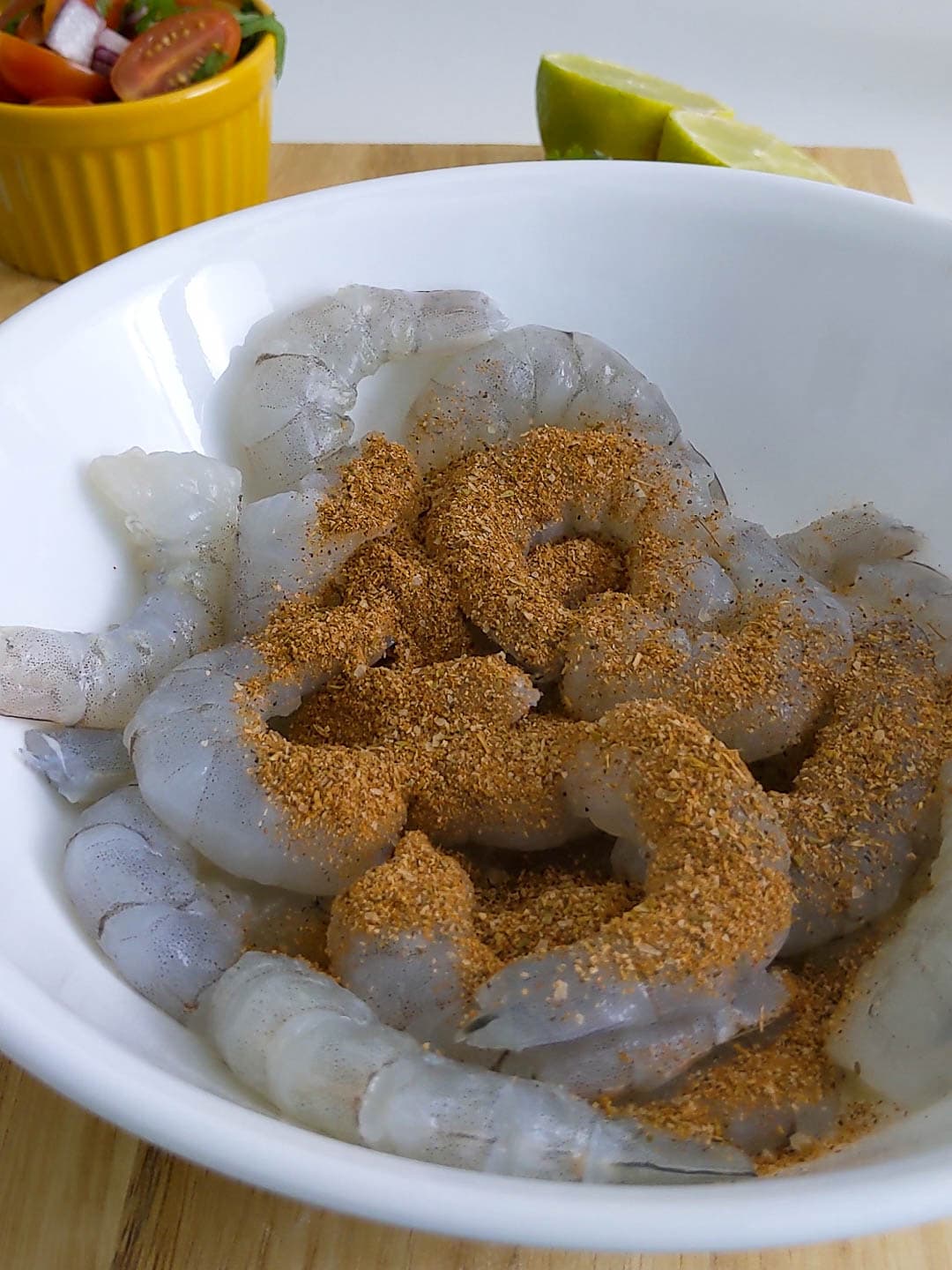adding spices to the raw shrimp