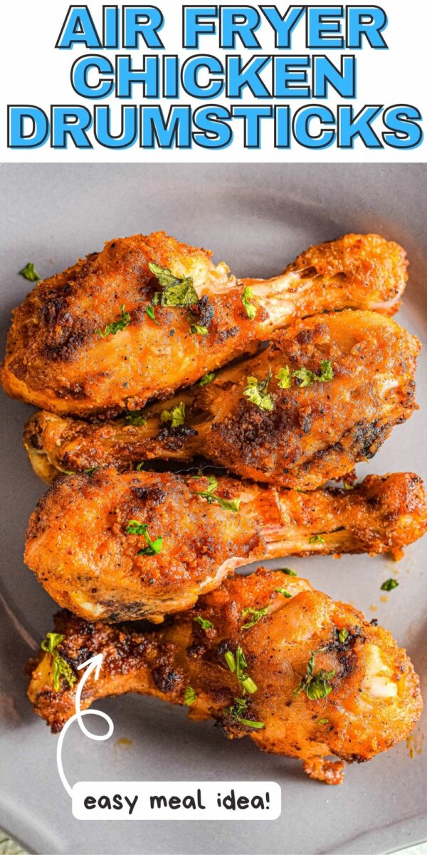 Four crispy, seasoned air fryer chicken legs arranged on a gray plate with text above reading "AIR FRYER CHICKEN DRUMSTICKS" and text below reading "easy meal idea!".