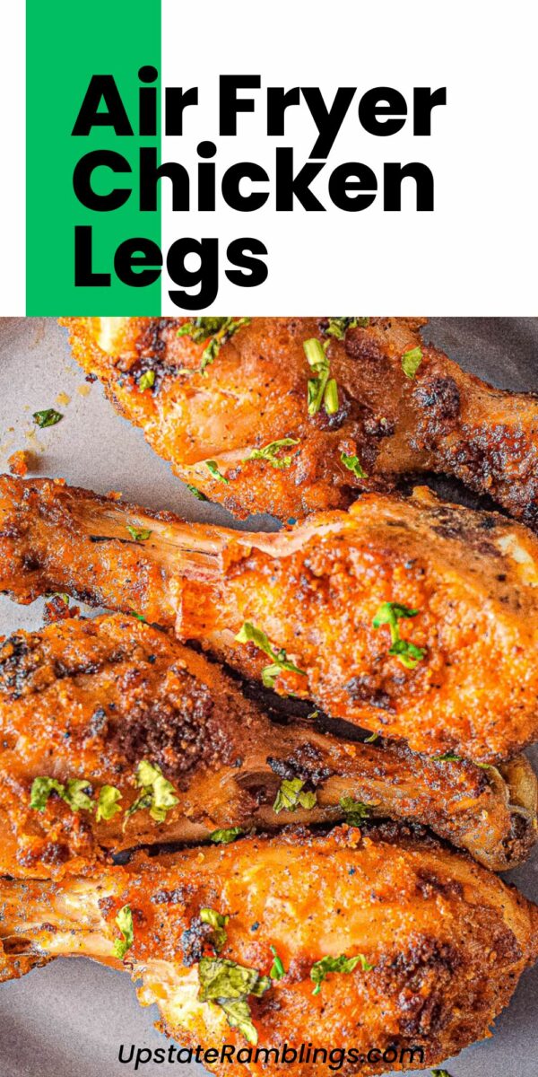 Air fryer chicken legs garnished with herbs, presented on a gray plate. Text in the image reads "Delicious Air Fryer Chicken Legs" with the website name "Upstate Ramblings" at the bottom.