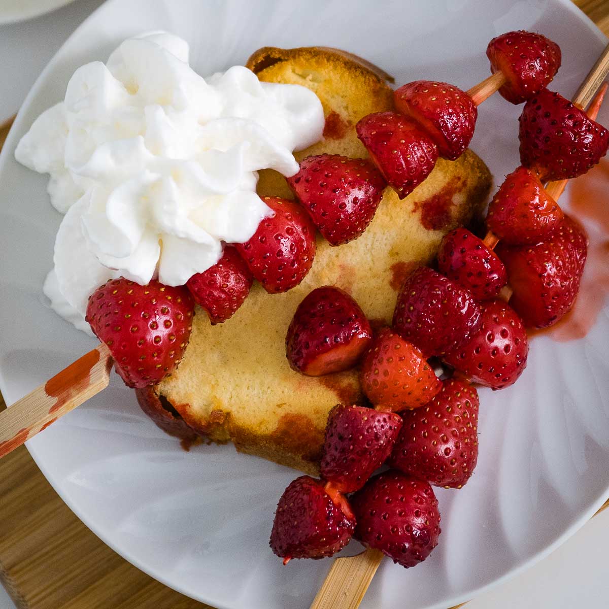 Air Fryer Strawberry Shortcake with whipped cream on a plate.