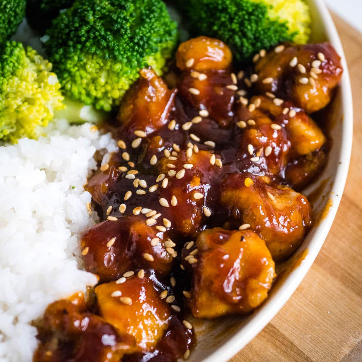 General Tso's Chicken on a plate with broccoli and rice.