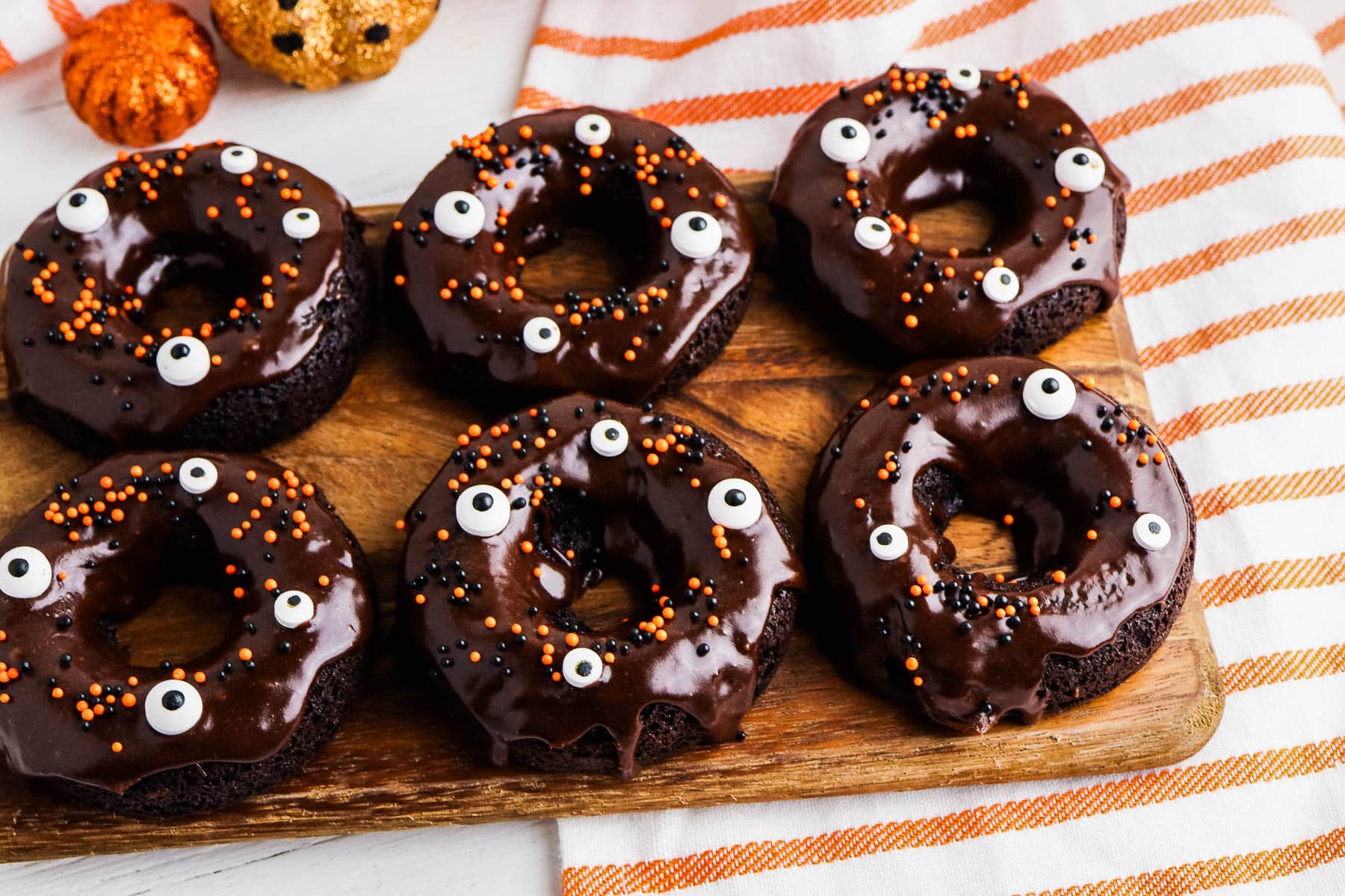 Chocolate Cake Mix Donuts decorated for halloween with frosting and sprinkles.