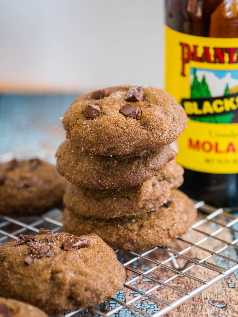 stack of cookies with jar of molasses in background