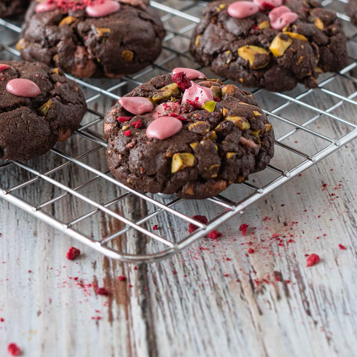 Ruby chocolate chip cookies on a cooling rack.