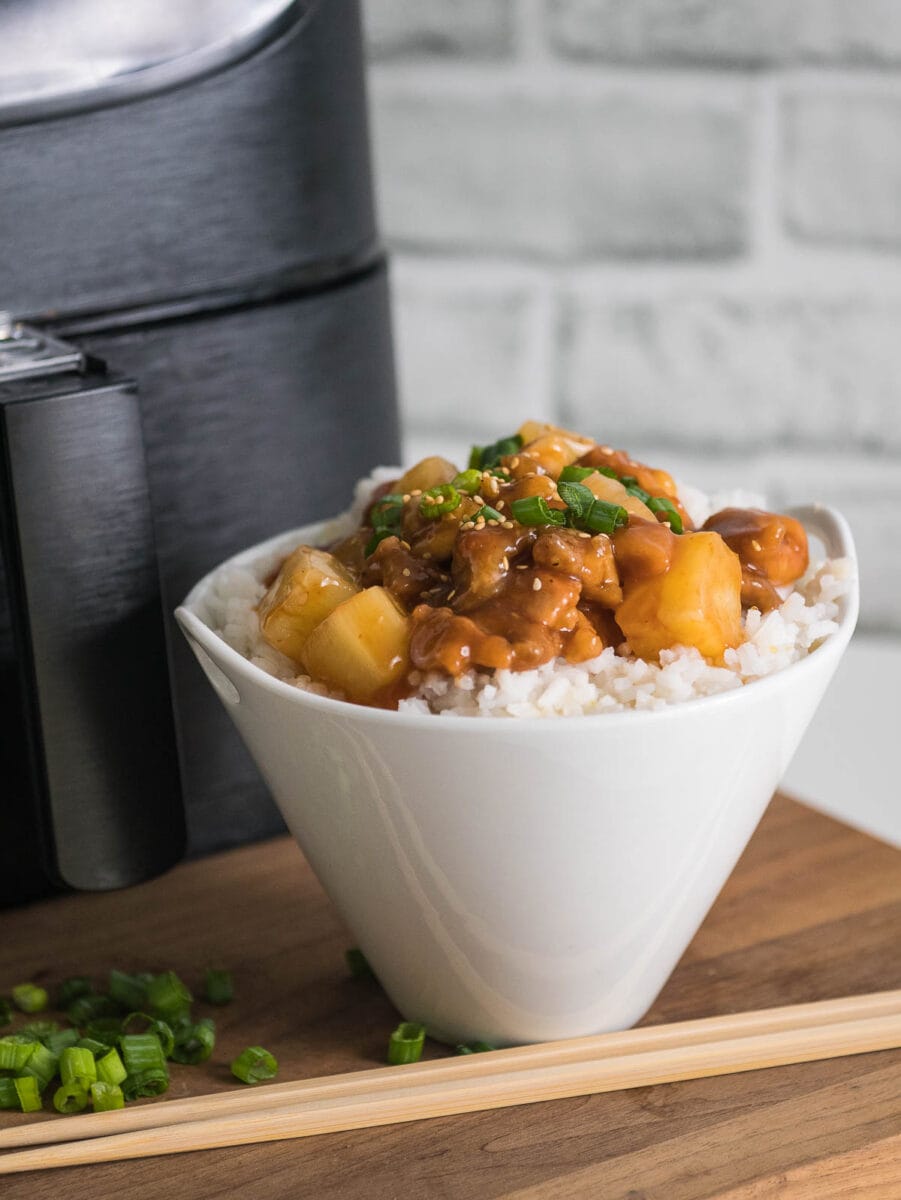 bowl of sweet and sour chicken in front of air fryer
