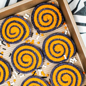 halloween pinwheel cookies on a silver tray with sprinkles
