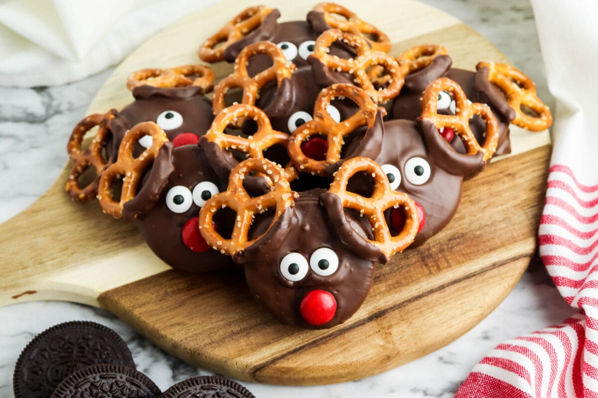 group of chocolate covered oreo reindeer on a cutting board