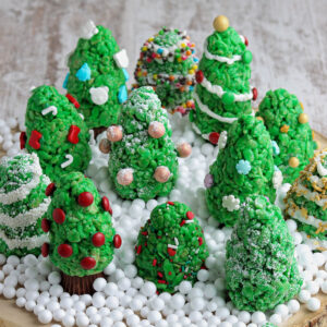 grouping of rice krispie christmas trees on a cutting board.