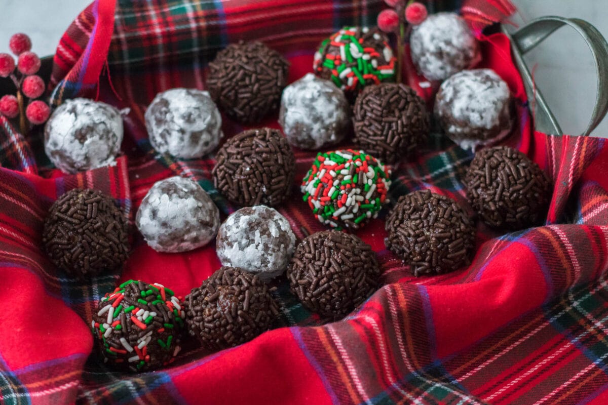 chocolate rum balls on a tray with plaid fabric