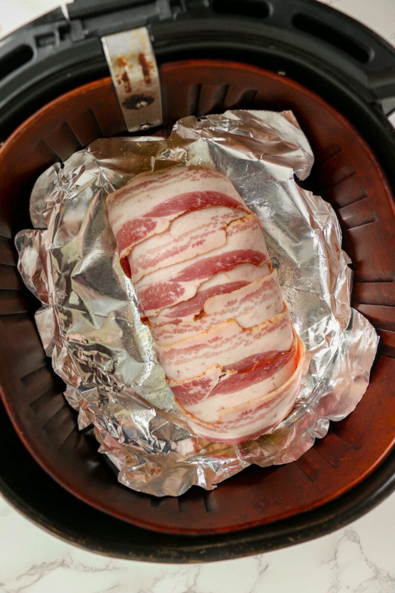 bacon wrapped turkey meatloaf before air frying.