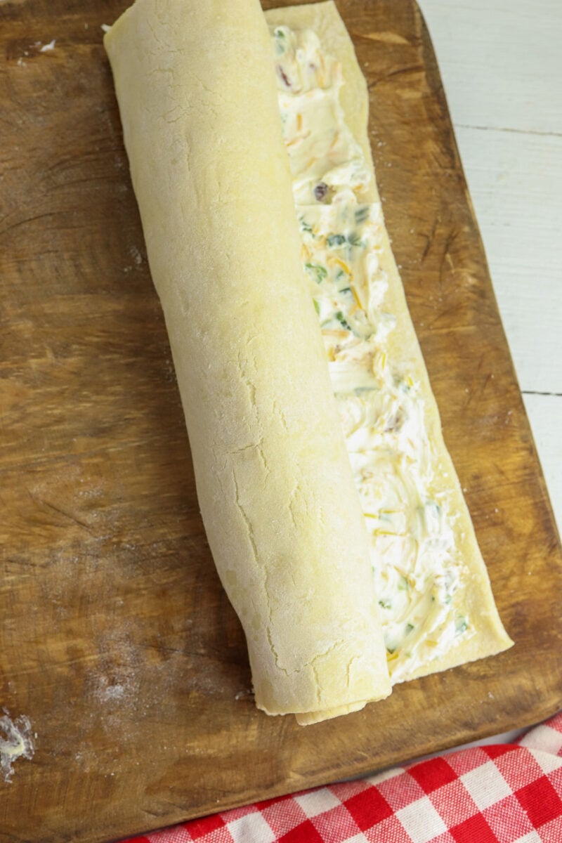 roll up the puff pastry with cheese filling.