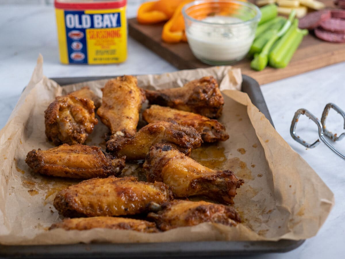 wings on a tray with old bay in the background