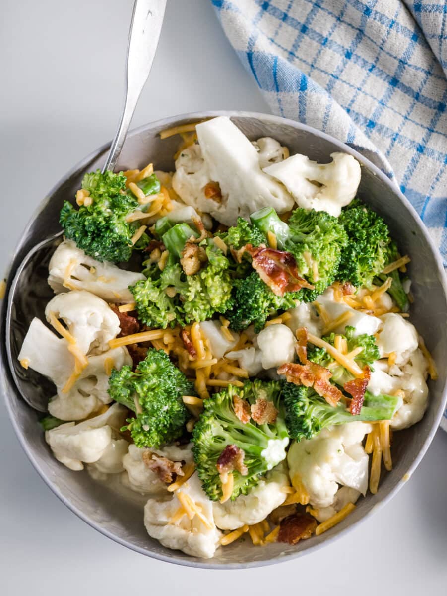 top view of broccoli cauliflower salad in a bowl.