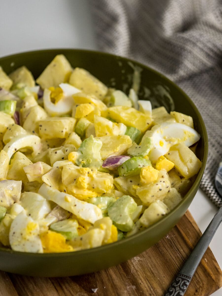 Amish potato salad with eggs and mustard in a bowl.