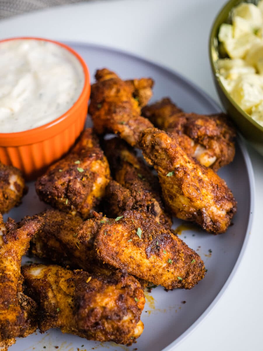 air fryer cajun wings with dipping sauce.