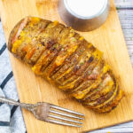 top view of an air fryer hasselback potatoes.