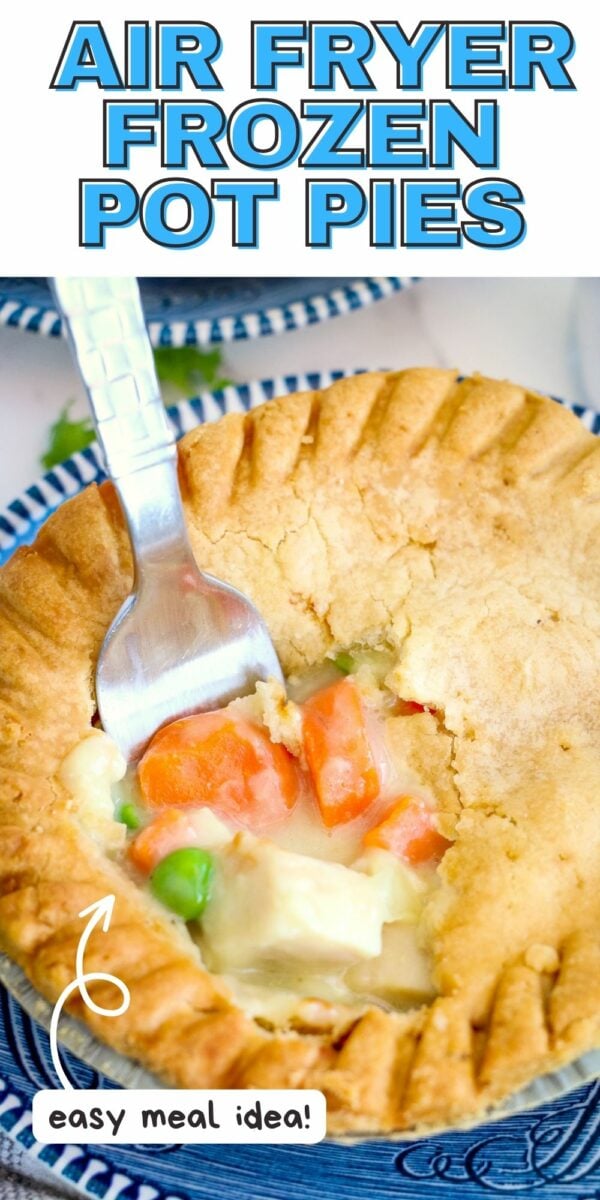 A fork is inserted into a partially cut air fryer frozen pot pie on a blue and white plate. Text on the image reads: "Air Fryer Frozen Pot Pies" and "easy meal idea!" Enjoy delicious air fryer frozen pot pies in no time.