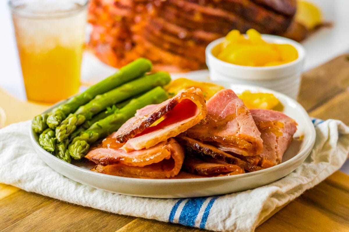 plate full of ham with asparagus.