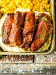 Bbq pork tenderloin with mashed potatoes and corn.