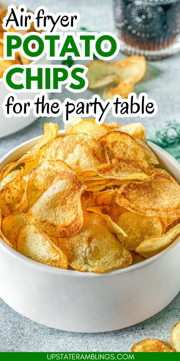 A white bowl filled with golden air fryer potato chips sits on a table, with text reading “Air fryer potato chips for the party table.”.
