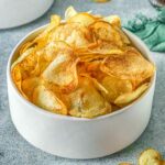 Closeup of air fryer potato chips in a white bowl.