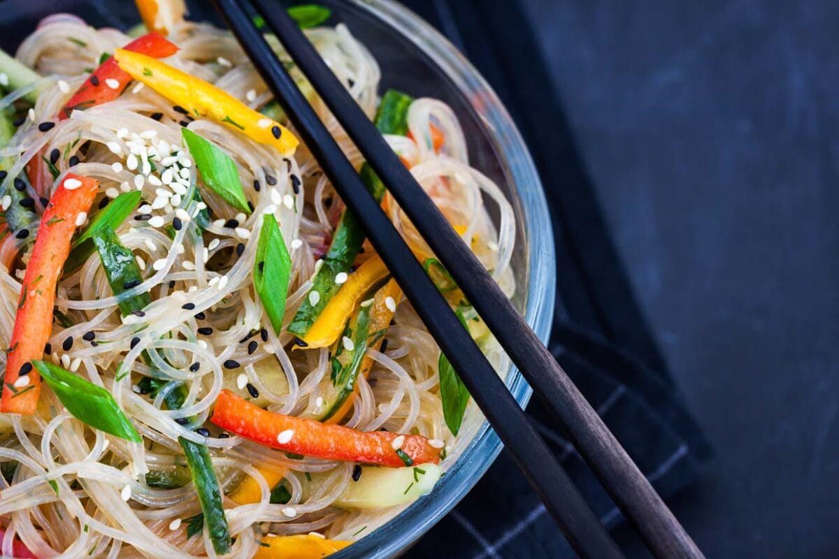 Asian rice glass noodles in a bowl with veggies.