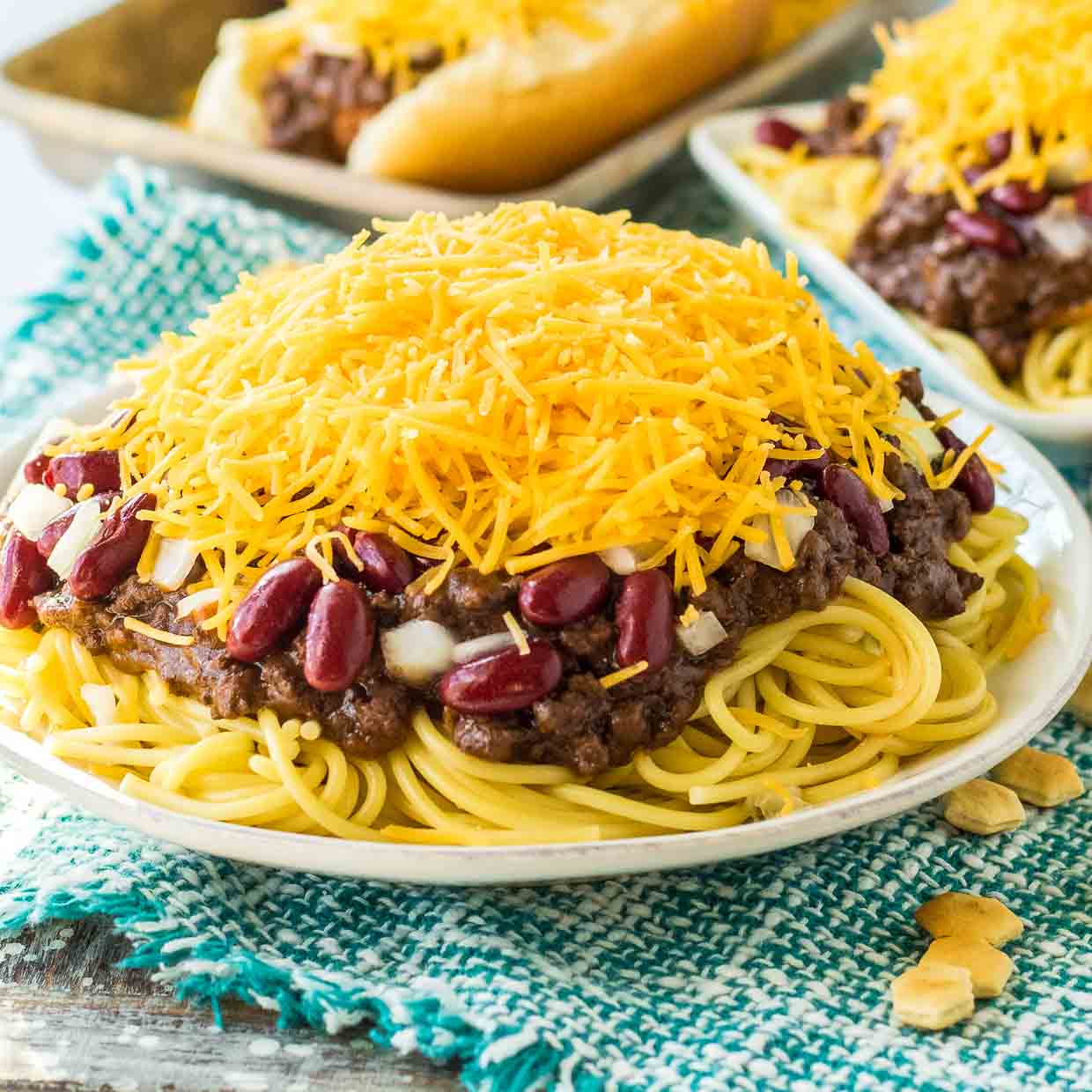 Cincinnatti chili on top of spaghetti and covered with cheese, beans and onions.
