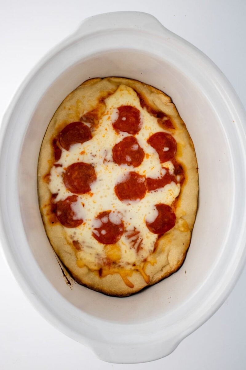 top view of pepperoni crock pot pizza in the slow cooker.