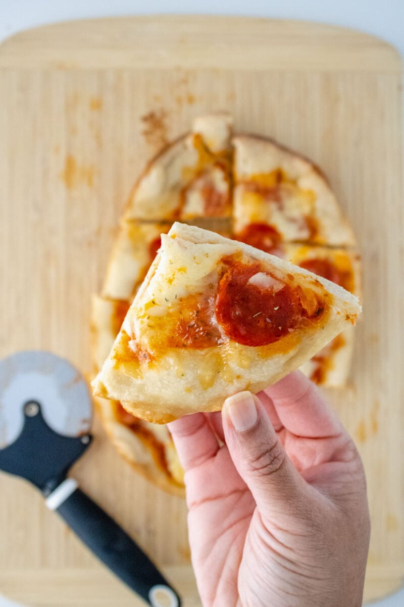 piece of pepperoni pizza sliced for eating.