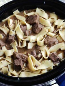 pinterest pin for beef and noodles in a slow coooker.