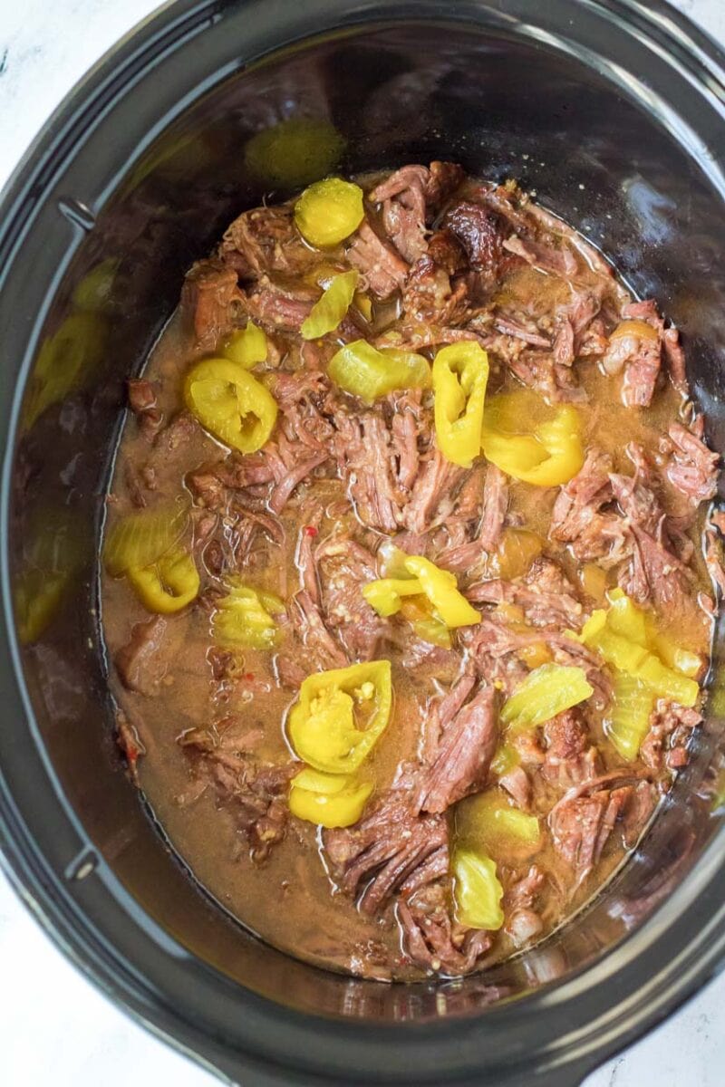 Italian beef in crockpot after cooking and shredding.